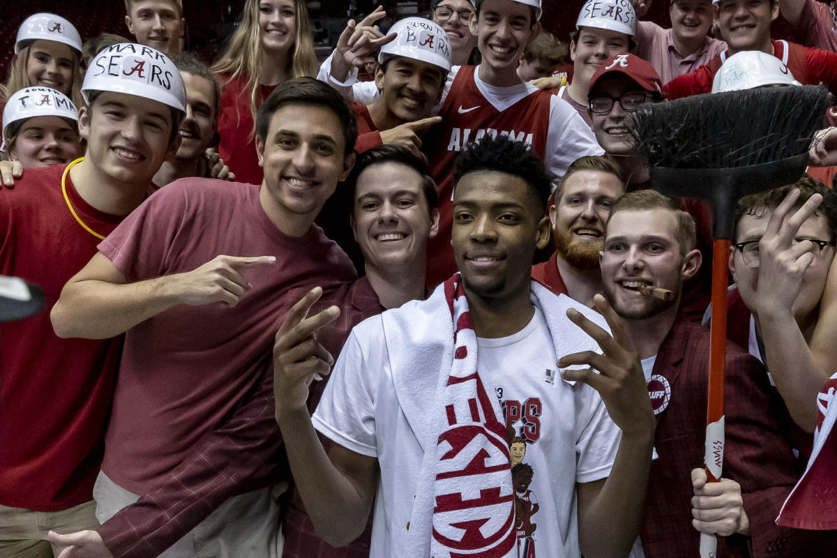 Alabama basketball's Brandon Miller is protected by ARMED SECURITY