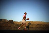 Keith Straw, 58, competes dressed in a tutu during the Badwater Ultramarathon in Death Valley National Park, California in this July 15, 2013 file photo. An ultramarathon involves a combination of running and walking further than the traditional marathon of 26.2 miles (42.2 kilometres). Though most ultras cover distances of either 50 or 100 miles, many are much longer. For the ultramarathoner, it is all about running for joy, setting personal goals and trying to overcome every obstacle faced. To match ATHLETICS-ULTRAMARATHONS/ REUTERS/Lucy Nicholson/Files (UNITED STATES - Tags: SPORT ATHLETICS)