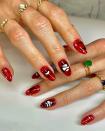 For a more seductive Halloween aesthetic, paint your nails wine red and decorate with celestial and snake <a href="https://www.glamour.com/story/diy-gel-nail-polish-stickers?mbid=synd_yahoo_rss" rel="nofollow noopener" target="_blank" data-ylk="slk:nail decals;elm:context_link;itc:0;sec:content-canvas" class="link ">nail decals</a>.