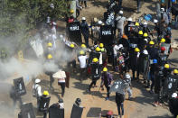 Protesters are dispersed as Riot Police fire tear gas in Tharkata Township, on the outskirts of Yangon, Myanmar, Saturday, March 6, 2021. Demonstrators defied growing violence by Myanmar security forces and staged more anti-coup rallies Friday, while the U.N. special envoy for the country called for urgent Security Council action, saying about 50 peaceful protesters were killed and scores were injured in the military's worst crackdowns this week. (AP Photo)