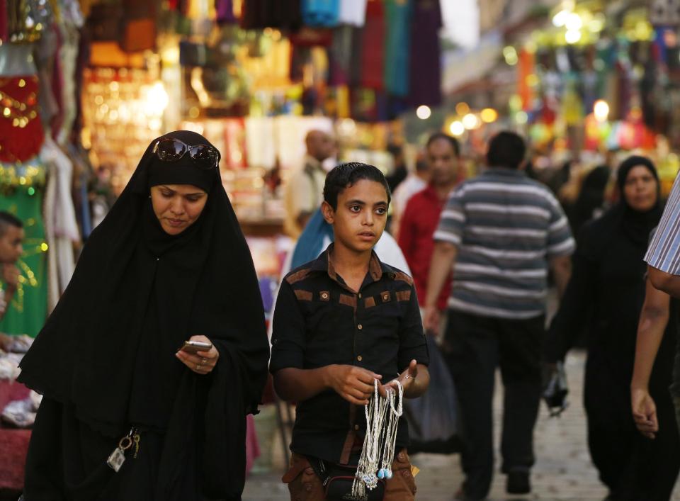 A street vendor selling trinkets looks for customers in the Khan El-Khalili market, normally a popular tourist destination, in Cairo, Egypt, Monday, Sept. 9, 2013. Before the 2011 revolution that started Egypt's political roller coaster, sites like the pyramids were often overcrowded with visitors and vendors, but after a summer of coup, protests and massacres, most tourist attractions are virtually deserted to the point of being serene. (AP Photo/Lefteris Pitarakis)