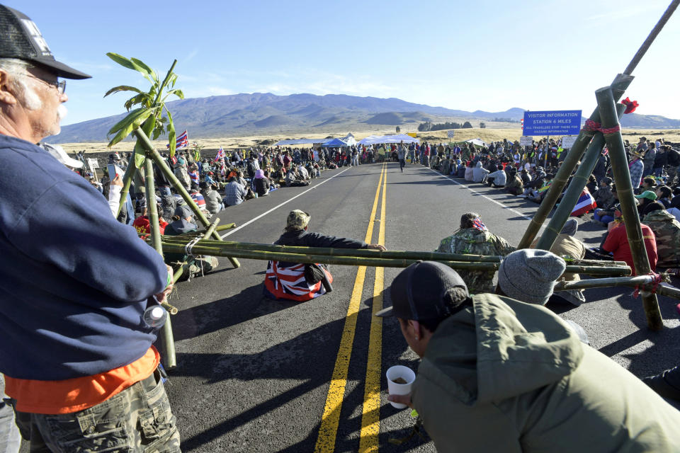 FILE: In this file photo from Friday, July 19, 2019, protesters continue their opposition vigil against the construction of the Thirty Meter Telescope at Mauna Kea on the Big Island of Hawaii Hawaii officials are demobilizing law enforcement at a mountain where protesters are blocking construction of a giant telescope because the project isn't moving forward for now. An international consortium wants to build the Thirty Meter Telescope on Mauna Kea, Hawaii's tallest peak. But some Native Hawaiians believe the telescope will desecrate sacred land. Protesters have stopped construction from going forward since mid-July. (Bruce Asato/Honolulu Star-Advertiser via AP)