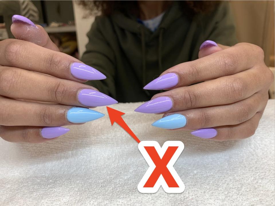 Stiletto nail shape with gel polish in blue and purple.