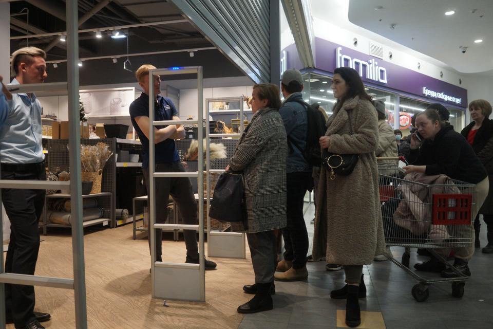 People queue outside the entrance to a JYSK store in Moscow, Russia.