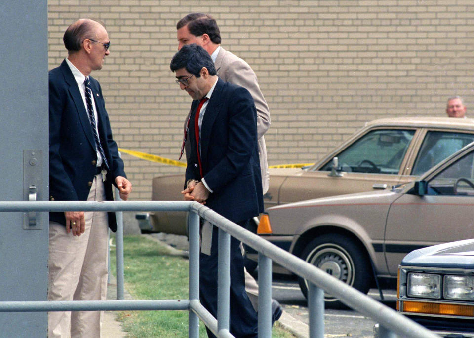 FILE - In this June 22, 1988 file photo, Walid Mourad, center, one of three defendants of Lebanese descent from Montreal, Canada, is led into federal court in handcuffs in Burlington, Vt. Mourad and the two others were caught smuggling the makings of a bomb into the U.S., on Oct. 23, 1987, in Richford, Vt. All three were convicted and sent to federal prison. (AP Photo/Toby Talbot, File)