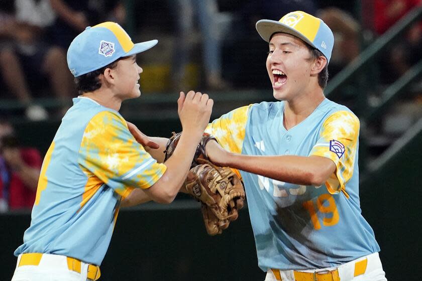 El Segundo, Calif.'s Brody Brooks, left, and Louis Lappe (19) celebrate the team's win against Nolensville, Tenn., during a baseball game at the Little League World Series in South Williamsport, Pa., Wednesday, Aug. 23, 2023. (AP Photo/Tom E. Puskar)