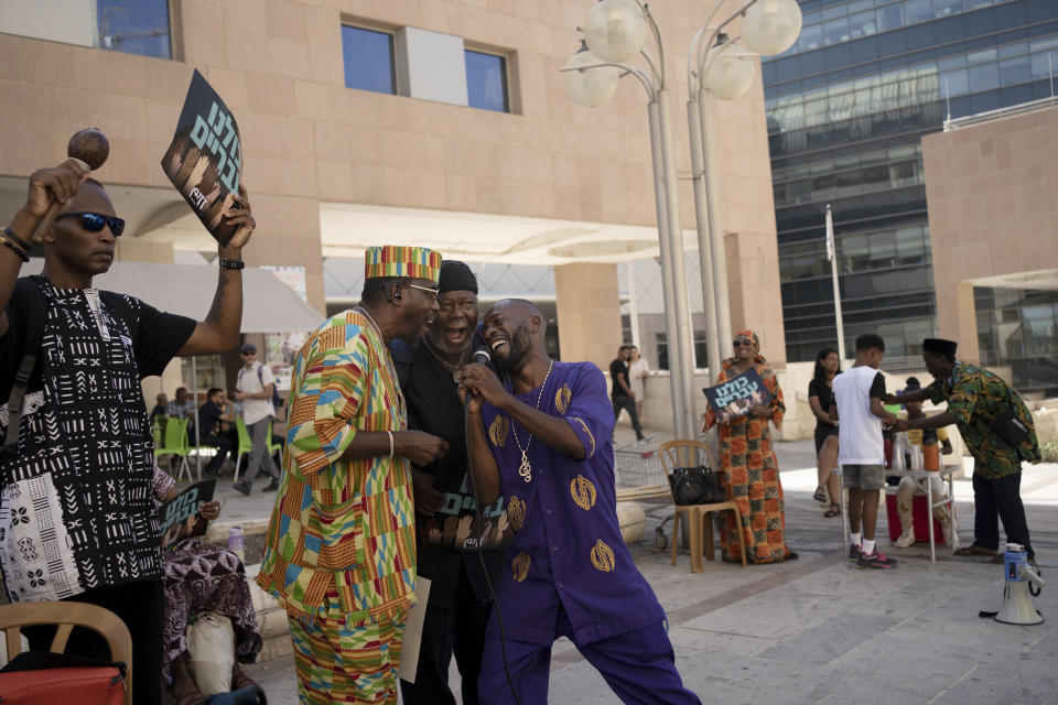 Members of the African Hebrew Israelites of Jerusalem sing together during a rally outside of the District Court in Beersheba, Israel, ahead of a hearing on the deportation orders for dozens from their community, Wednesday, July 19, 2023. The community's decades-long plight to secure their status shines a light on Israel's strict immigration policy, which grants people whom it considers Jewish automatic citizenship but limits entry to others who don't fall within that definition. (AP Photo/Maya Alleruzzo)