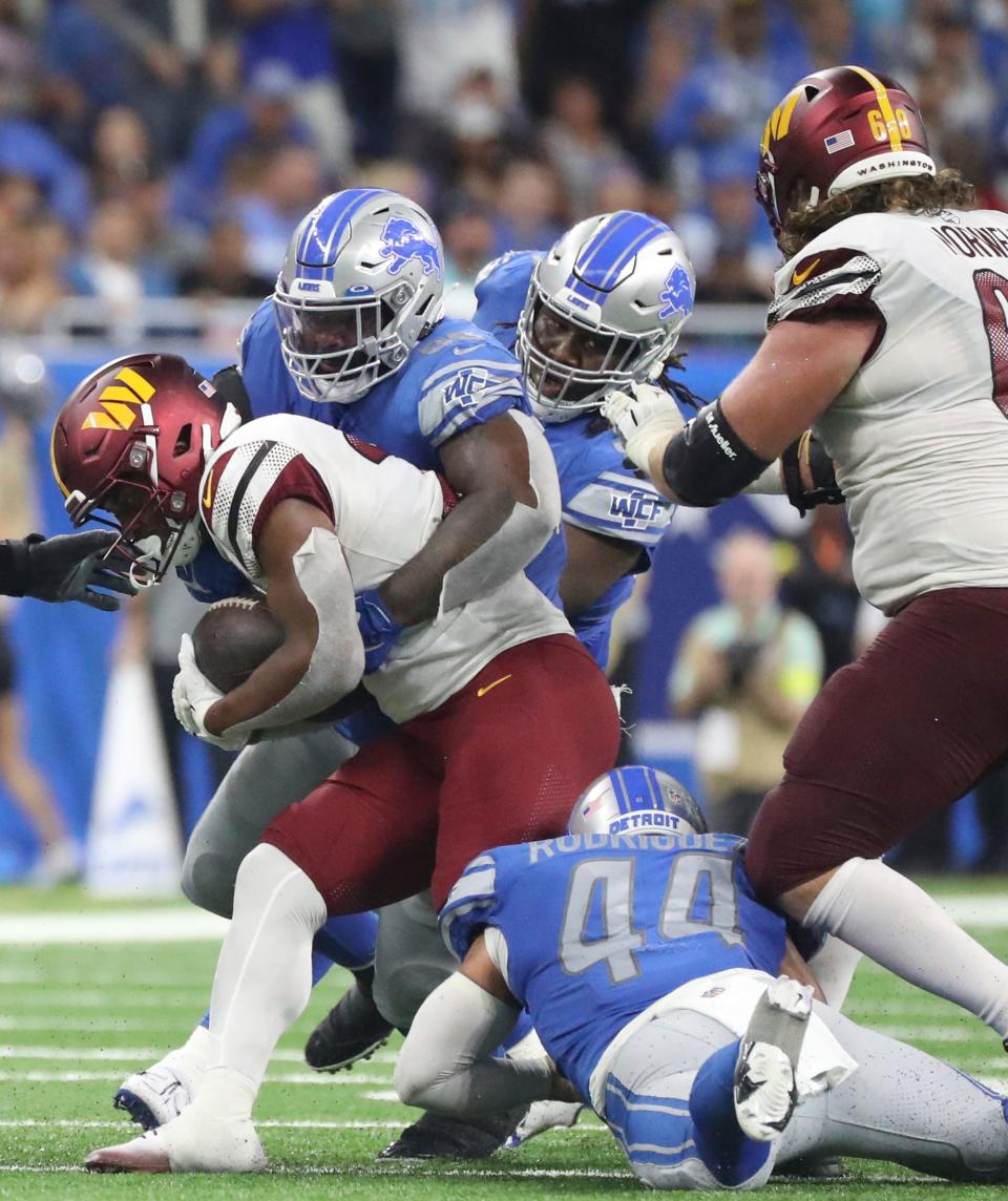 Sep 18, 2022; Detroit, Michigan, USA; Detroit Lions defensive end Isaiah Buggs (96) tackles Washington Commanders running back Antonio Gibson (24) during second half action at Ford Field.