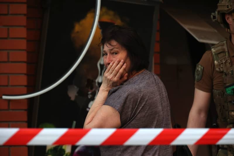 A woman cries near an office building that was destroyed by a Russian missile attack in the center of Kharkiv in northeastern Ukraine. -/Ukrinform/dpa