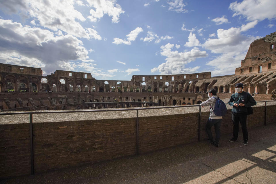 Tourists visit the Colosseum, in Rome, Saturday, March 7, 2020. With the coronavirus emergency deepening in Europe, Italy, a focal point in the contagion, risks falling back into recession as foreign tourists are spooked from visiting its cultural treasures and the global market shrinks for prized artisanal products, from fashion to design. (AP Photo/Andrew Medichini)