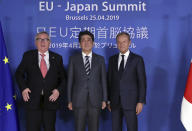 Japan's Prime Minister Shinzo Abe, center, poses with European Commission President Jean-Claude Juncker, left, and European Council President Donald Tusk during an EU-Japan summit at the European Council building in Brussels, Thursday, April 25, 2019. Japanese Prime Minister Shinzo Abe and top EU officials are discussing trade, bilateral ties and North Korea. (AP Photo/Francisco Seco, Pool)