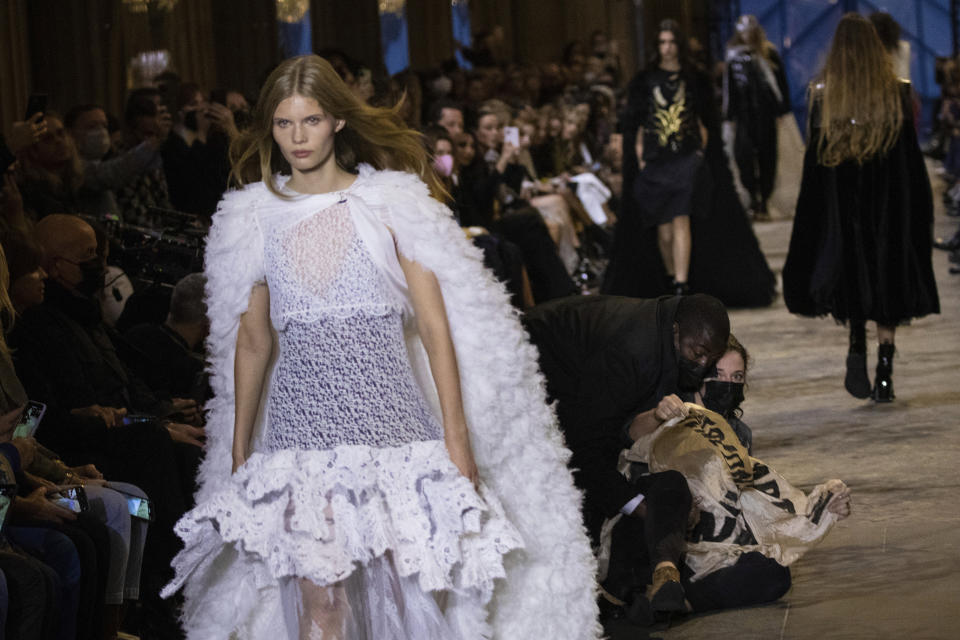 A protester is removed from the runway during the Louis Vuitton Spring-Summer 2022 ready-to-wear fashion show presented in Paris, Tuesday, Oct. 5, 2021. (Photo by Vianney Le Caer/Invision/AP)