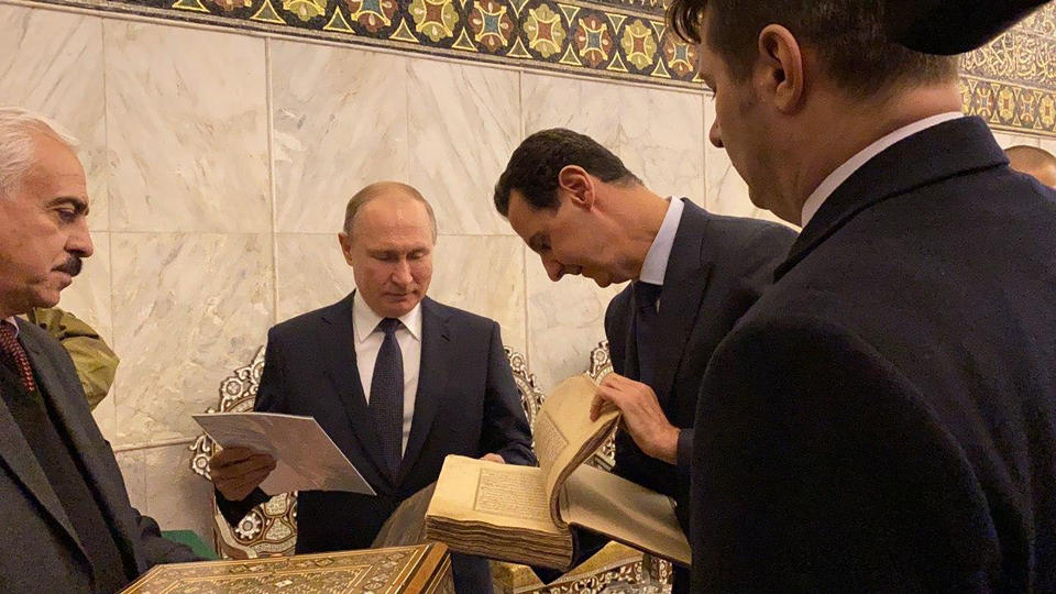 This image released by the Syrian Presidency shows Russian President Vladimir Putin, center, and Syrian President Bashar Assad, second right, during a visit to the Umayyad Mosque in Damascus, Syria, Tuesday, Jan. 7, 2020. Putin's visit is the second to the war-torn country where his troops have been fighting alongside Syrian government forces since 2015. (Syrian Presidency via AP)