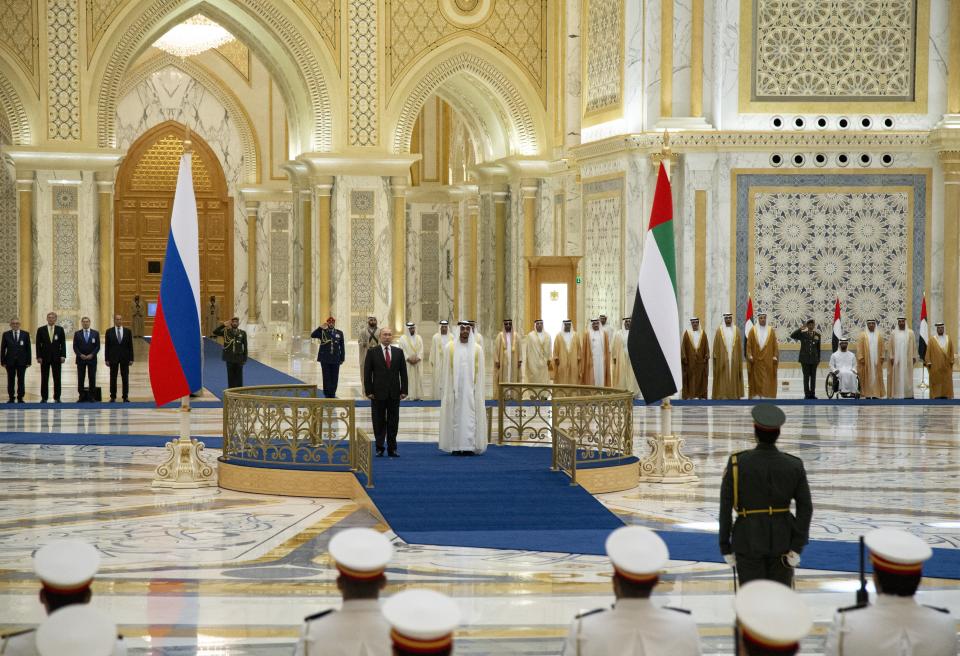 Russian President Vladimir Putin, center left, and Abu Dhabi Crown Prince Mohamed bin Zayed al-Nahyan, center right, attend the official welcome ceremony in Abu Dhabi, United Arab Emirates, Tuesday, Oct. 15, 2019. (AP Photo/Alexander Zemlianichenko, Pool)