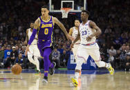 Los Angeles Lakers' Kyle Kuzma, left, drives upcourt agaisnt Philadelphia 76ers' Jimmy Butler, right, during the first half of an NBA basketball game, Sunday, Feb. 10, 2019, in Philadelphia. (AP Photo/Chris Szagola)