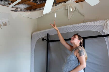 Jennifer Maher, pregnant in her third trimester, looks over damage to her home post-Hurricane Florence at Marine Corps Base Camp Lejeune, North Carolina, U.S., September 27, 2018. REUTERS/Andrea Januta
