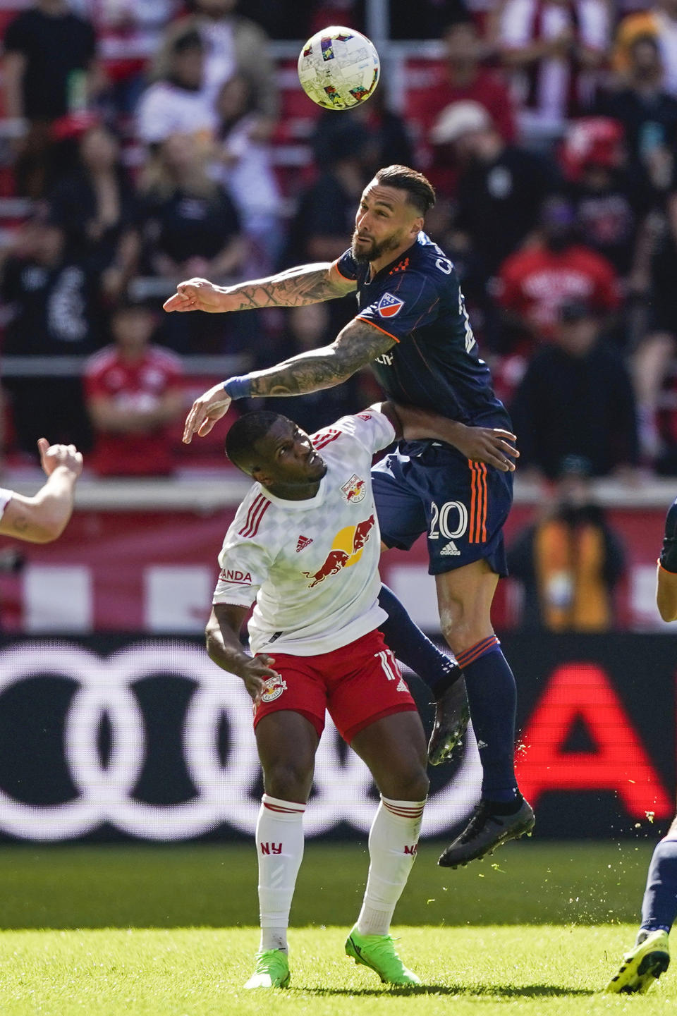 FC Cincinnati defender Geoff Cameron (20) heads the ball over New York Red Bulls forward Ashley Fletcher (11) during an MLS playoff soccer match, Saturday, Oct. 15, 2022, in Harrison, N.J. (AP Photo/Eduardo Munoz Alvarez)