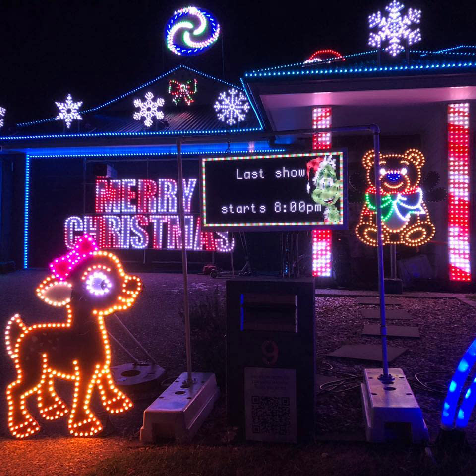 A sign shows the time of the show outside a Christmas display in Ormeau, Gold Coast.