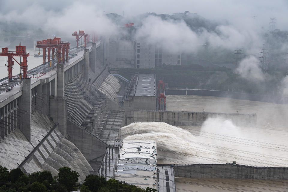 In this photo released by China's Xinhua News Agency, water flows out from sluiceways at the Three Gorges Dam on the Yangtze River near Yichang in central China's Hubei Province, Friday, July 17, 2020. Engorged with more heavy rains, China's mighty Yangtze River is cresting again, bringing fears of further destruction as seasonal floods that already have left more than a hundred people dead or missing have grown in force since last month. (Zheng Jiayu/Xinhua via AP)