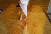 FILE PHOTO: A woman poses for a photo at the gold-plated infinity pool of the newly inaugurated Dolce Hanoi Golden Lake luxury hotel, after the government eased a nationwide lockdown following the global outbreak of the coronavirus disease (COVID-19), in H