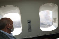 Turkey's President Recep Tayyip Erdogan watches from his plane the wildfires in Manavgat, Antalya, Turkey, Saturday, July 31, 2021. The death toll from wildfires raging in Turkey's Mediterranean towns rose to six Saturday after two forest workers were killed, the country's health minister said. Fires across Turkey since Wednesday burned down forests, encroaching on villages and tourist destinations and forcing people to evacuate.(Turkish Presidency via AP, Pool)