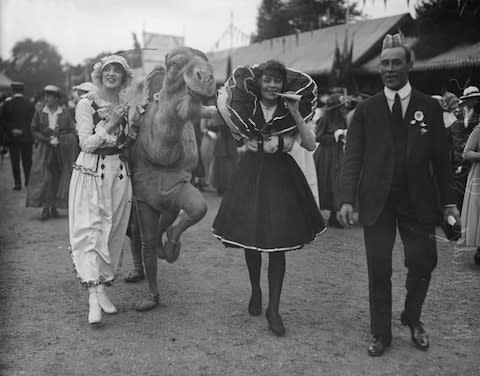 Fun and games at Kew Gardens. Yes, that is a camel - Credit: Topical Press Agency