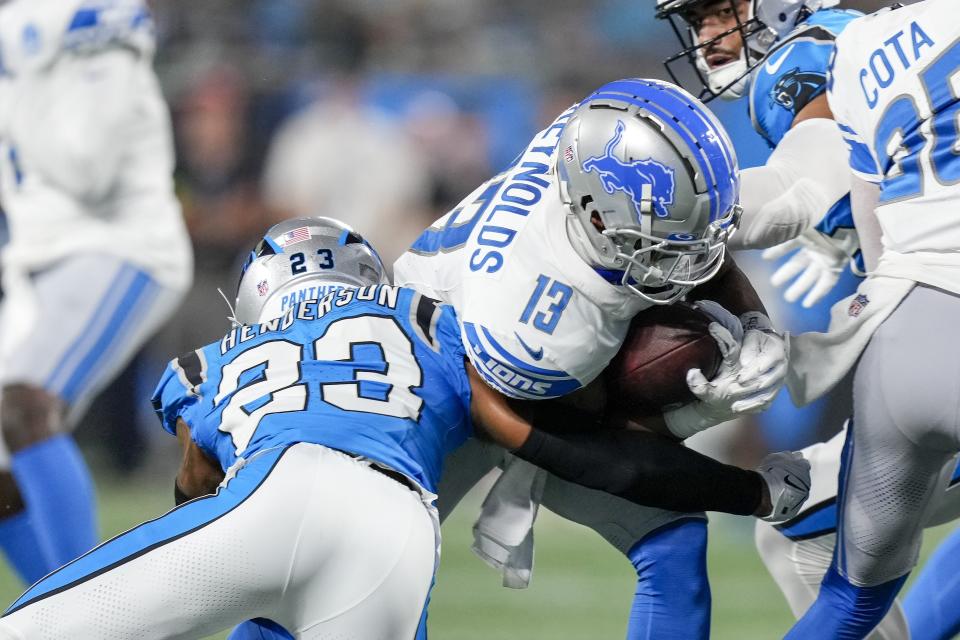 Aug 25, 2023; Charlotte, North Carolina, USA; Detroit Lions running back Craig Reynolds (13) is tackled by <a class="link " href="https://sports.yahoo.com/nfl/teams/carolina/" data-i13n="sec:content-canvas;subsec:anchor_text;elm:context_link" data-ylk="slk:Carolina Panthers;sec:content-canvas;subsec:anchor_text;elm:context_link;itc:0">Carolina Panthers</a> cornerback CJ Henderson (23) during the first quarter at Bank of America Stadium. Mandatory Credit: Jim Dedmon-USA TODAY Sports