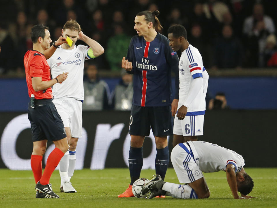 Football Soccer - Paris St Germain v Chelsea - UEFA Champions League Round of 16 First Leg - Parc des Princes, Paris, France - 16/2/16 Paris St Germain's Zlatan Ibrahimovic is shown a yellow card by referee Carlos Velasco Carballo after a foul on Chelsea's John Obi Mikel Action Images via Reuters / Lee Smith Livepic EDITORIAL USE ONLY.