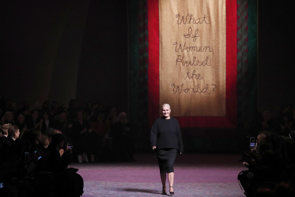 Designer Maria Grazia Chiuri accepts applause after the Dior Haute Couture Spring/Summer 2020 fashion collection presented Monday Jan. 20, 2020 in Paris. (AP Photo/Francois Mori)