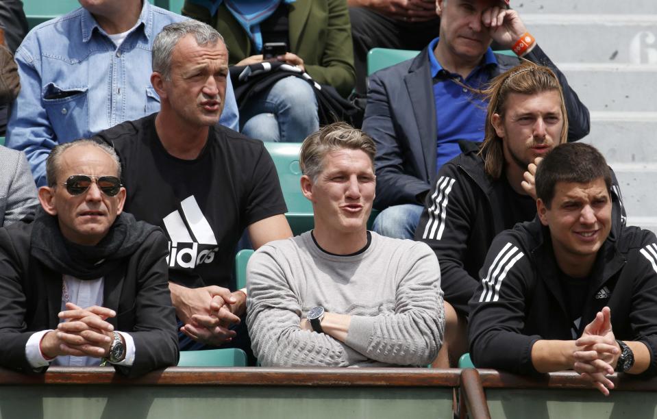 Bayern Munich's soccer player Bastian Schweinsteiger (C) watches the women's quarter-final match between Ana Ivanovic of Serbia and Elina Svitolina of Ukraine during the French Open tennis tournament at the Roland Garros stadium in Paris, France, June 2, 2015. REUTERS/Jean-Paul Pelissier