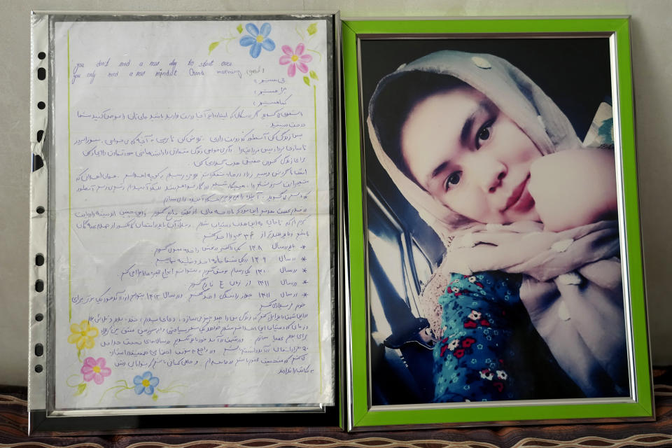 A note written by 20-year-old Vahida Heydari, who was victim of a suicide bombing on a Hazara education center, is placed next to her portrait, at her home in Kabul, Afghanistan, Sunday, Oct. 2, 2022. In it she says, I will shape my future as I want. She wrote that that she should become a doctor in 2029, work in a hospital by 2030 and become a professional painter in 2031. She wrote that she wants to be a respectable person in society and support those who cannot afford to go to school. (AP Photo/Ebrahim Noroozi)