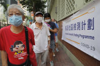 People wearing face masks queue for the coronavirus test outside a testing center in Hong Kong, Tuesday, Sept. 1, 2020. Hong Kong began a voluntary mass-testing program for coronavirus Tuesday as part of a strategy to break the chain of transmission in the city's third outbreak of the disease. The virus-testing program has become a flash point of political debate in Hong Kong, with many distrustful over resources and staff being provided by the China's central government and fears that the residents’ DNA could be collected during the exercise.(AP Photo/Kin Cheung)