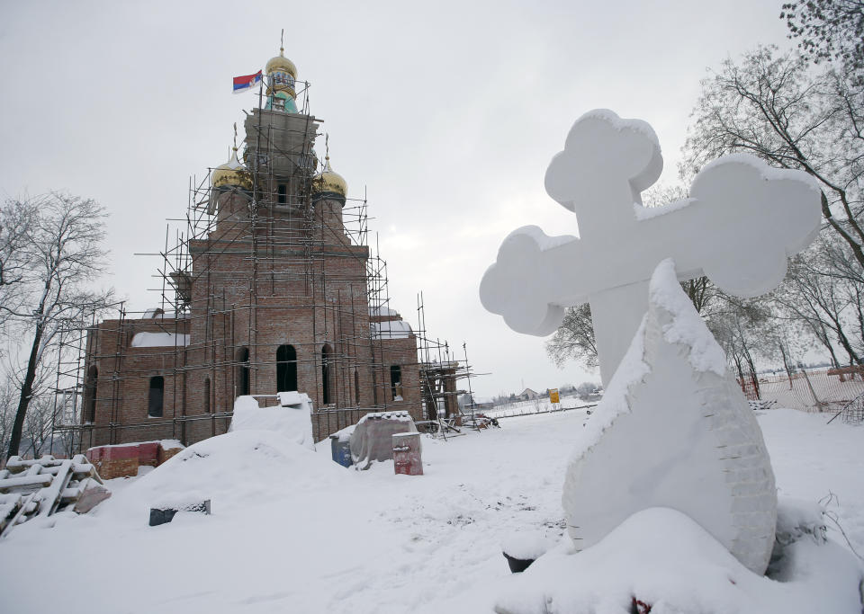 In this photo taken Friday, Jan. 11, 2019, the new church under construction designed in the Russian style in the village Banstol in northwestern Serbia. Topped with Russia-style green and gold onion-shaped domes, the church in this tiny village in northwestern Serbia is still under construction but it has already been dubbed ''Putin's church.'' (AP Photo/Darko Vojinovic)