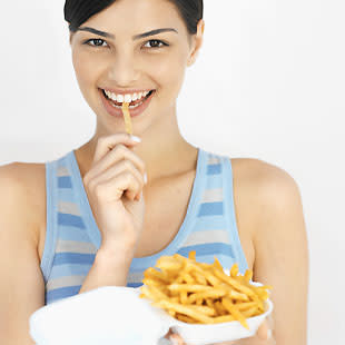 woman eating French fries