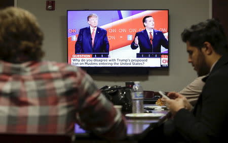 Muslim Student Association (MSA) West President Bashar Subeh (R), 20, a student at Cal Poly Pomona, watches the Republican presidential debate with other students at the Council on American-Islamic Relations (CAIR) office in Anaheim, California December 15, 2015. REUTERS/Jason Redmond