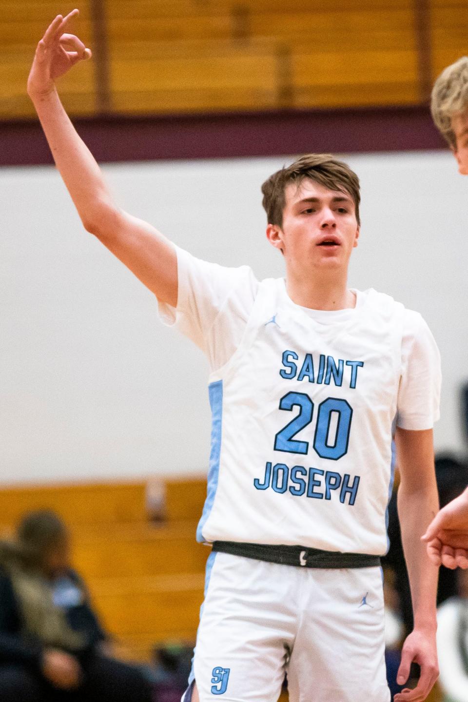 Saint Joseph's Chase Konieczny (20) celebrates a 3-point basket during the Saint Joseph vs. New Prairie sectional semifinal basketball game Friday, March 3, 2023 at Jimtown High School in Elkhart.