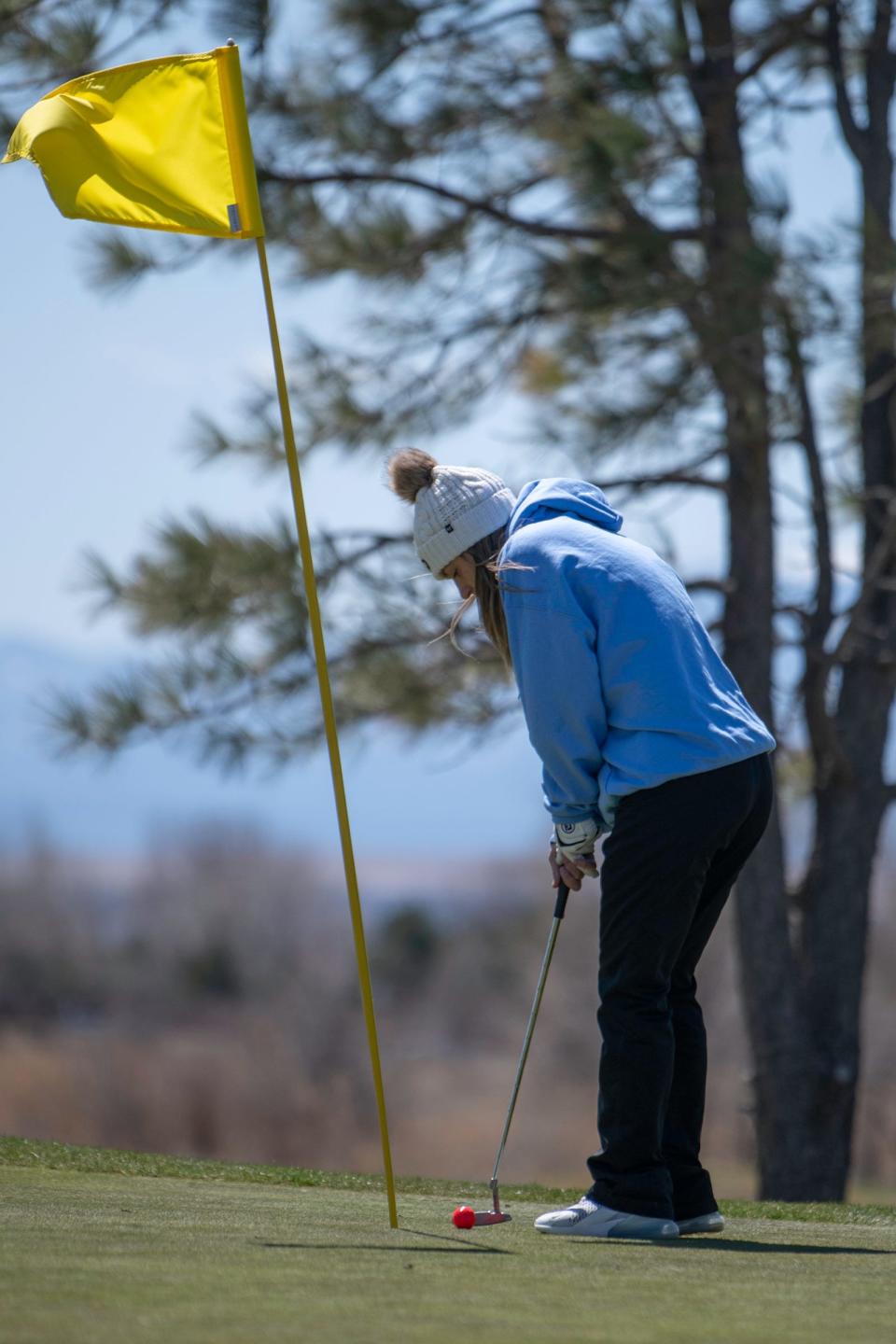 Pueblo West's Gianna Nardini lines up for a short putt on the 10th green during the Centennial girls golf tournament at Walking Stick Golf Course on Wednesday, April 6, 2022.