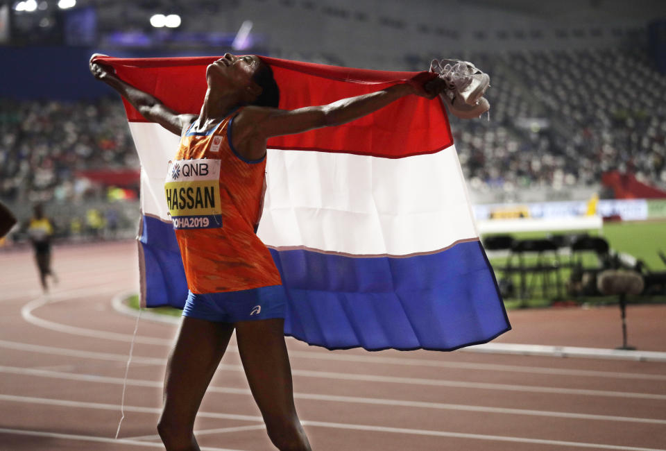 Sifan Hassan of the Netherlands celebrates after winning the gold in the women's 10,000m final at the World Athletics Championships in Doha, Qatar, Saturday, Sept. 28, 2019. (AP Photo/Nariman El-Mofty)