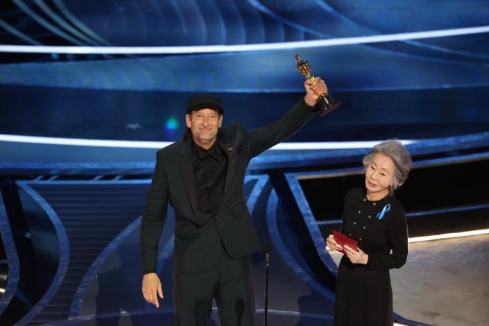 Troy Kotsur accepts the Actor in a Supporting Role award for &#39;CODA&#39; from Yuh-jung Youn at the 94th Academy Awards.