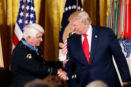 U.S. President Donald Trump shakes hands after awarding the Medal of Honor to James McCloughan, who served in the U.S. Army during the Vietnam War, during a ceremony at the White House in Washington, U.S. July 31, 2017. REUTERS/Joshua Roberts