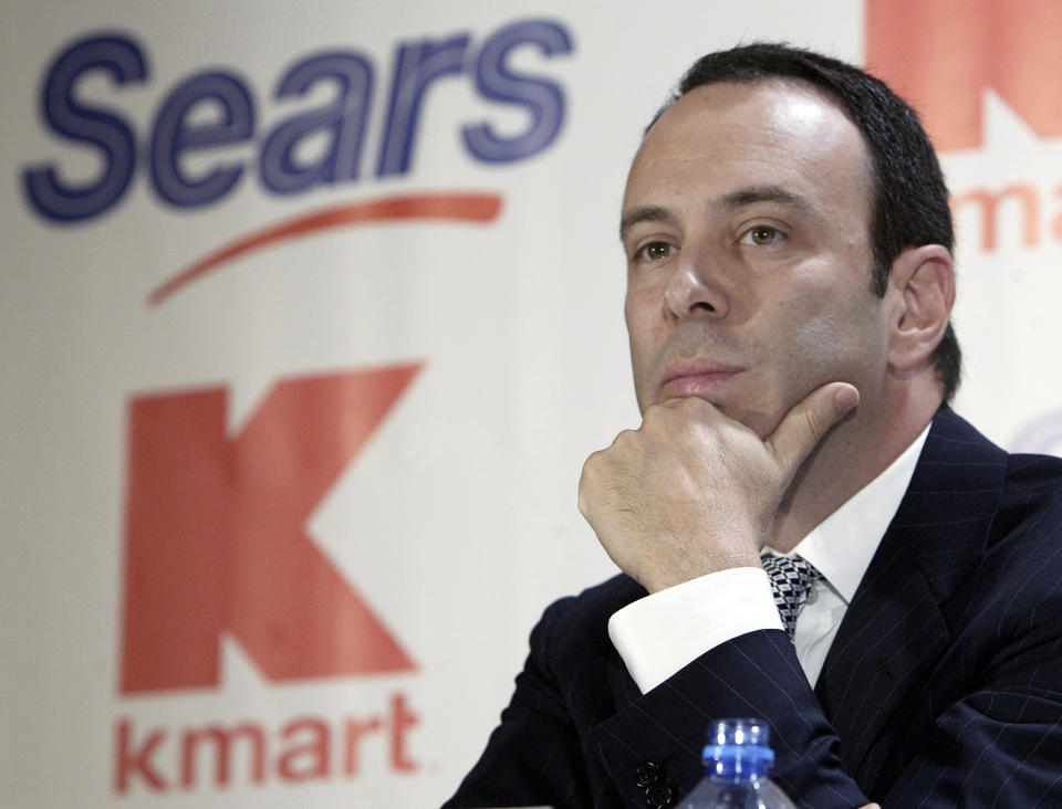 FILE- In this Nov. 17, 2004, file photo Kmart chairman Edward Lampert listens during a news conference to announce the merger of Kmart and Sears in New York. As Sears teeters on the brink of collapse, there’s one man at the center of the fight for the future of the iconic retailer. Lampert plays several, often conflicting, roles in what could be the final chapter for the company that began as a mail order watch business 132 years ago. He’s been chairman, CEO, landlord, lender, and largest shareholder all at the same time. If the company survives, he wins. If it ends up liquidating, he also wins. (AP Photo/Gregory Bull, File)
