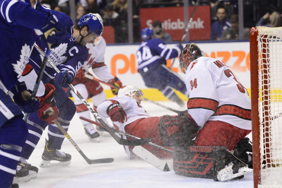 Toronto Maple Leafs centre John Tavares (91) looks for a rebound in front of Carolina Hurricanes goaltender Petr Mrazek (34) during second period NHL hockey action in Toronto, Monday, Dec. 23, 2019. (Frank Gunn/The Canadian Press via AP)