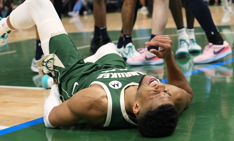 Bucks forward Giannis Antetokounmpo winces after being fouled during the first half.
