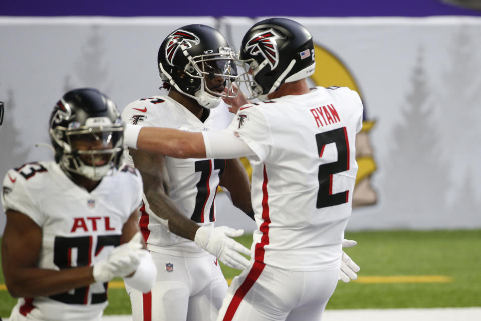 Atlanta Falcons wide receiver Julio Jones, left, celebrates with teammate Matt Ryan (2) after catching a 20-yard touchdown pass during the first half of an NFL football game against the Minnesota Vikings, Sunday, Oct. 18, 2020, in Minneapolis. (AP Photo/Bruce Kluckhohn)