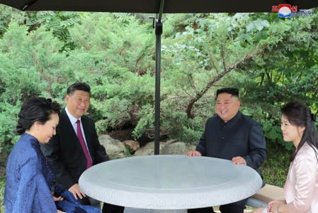 Chinese President Xi Jinping and North Korean leader Kim Jong Un take a walk in Pyongyang