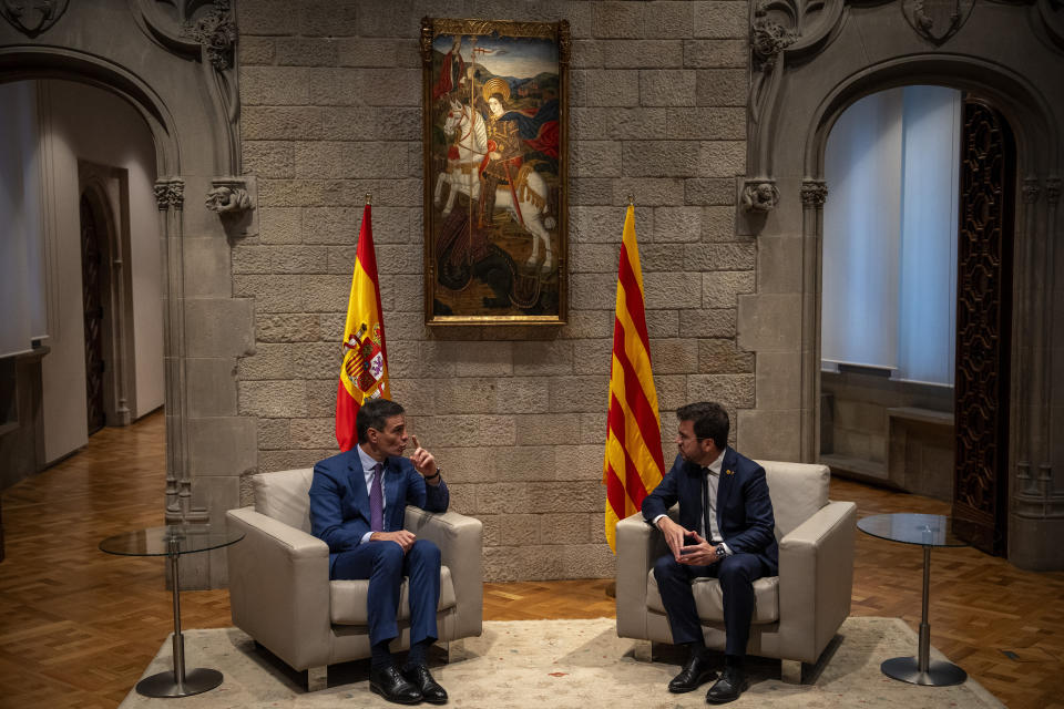 Spanish Prime Minister Pedro Sanchez, left, talks with Catalonia's President Pere Aragones during a meeting in Barcelona, Spain, Thursday, Dec. 21, 2023. Sanchez and Aragones meet in the first encounter since an amnesty for Catalan separatists was announced earlier this year. (AP Photo/Emilio Morenatti)