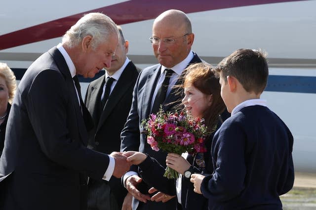 The King was greeted by Ella Smith and Lucas Watt, both 10, as he arrived at George Best Belfast City Airport 