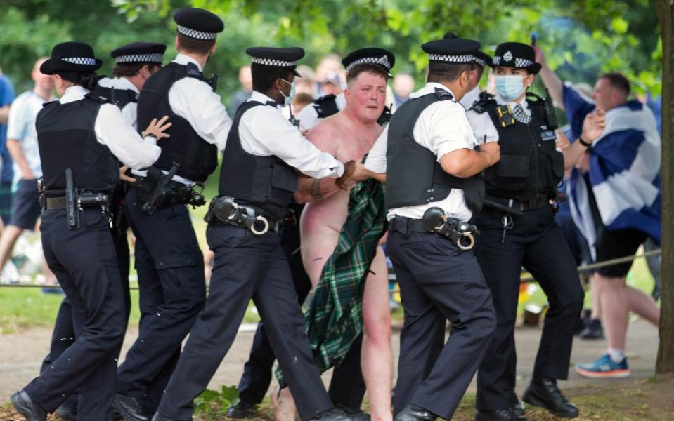 A naked fan is led away by police - I-IMAGES PICTURE AGENCY