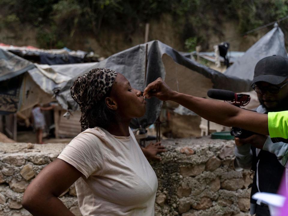 woman taking oral cholera vaccine