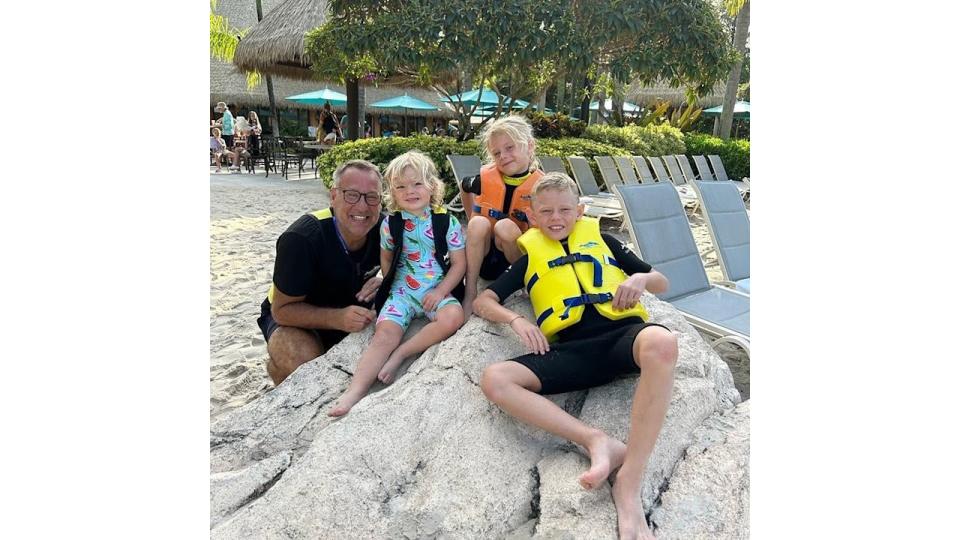 Paul merson with his three children at beach